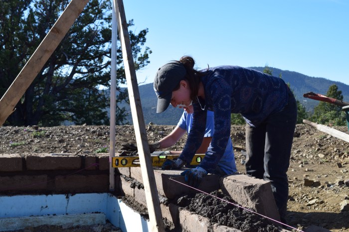 Emily laying an adobe.JPG